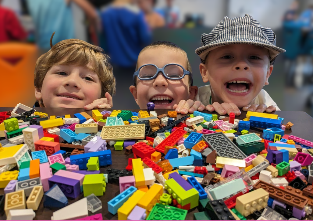 Birthday party guest building with LEGO bricks at a Baseplate Labs event